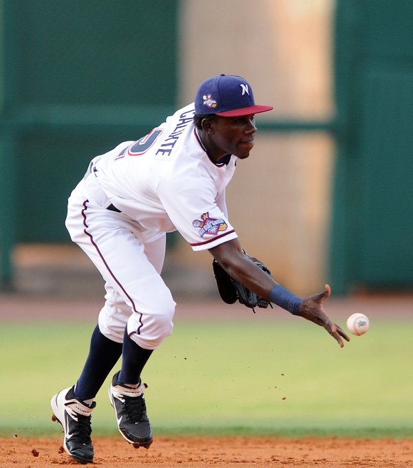 Orlando Calixte of the Northwest Arkansas Naturals tosses the ball to second base during the game against the Springfield Cardinals Friday, July 19, 2013, at Arvest Ballpark in Springdale. Friday's game was the second of four in the series against the Cardinals