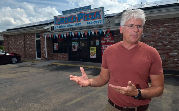 Rolf Wilkin, owner of Eureka Pizza, talks Thursday morning about the details of the 40 solar panels he had installed on the top of Eureka Pizza on N Leverett Ave in Fayetteville.  Wilkin says he expects to make up the money he invested in the panels in about 5 years.
