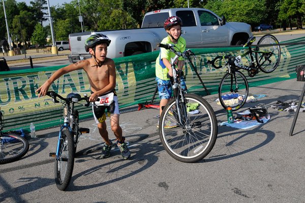 Parker Miller heads out on his bike during the SharkFest Triathlon on Saturday in Bentonville.