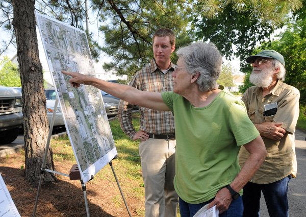 Nan Lawler, center, points to a map of the proposed extension to Frisco Trail Monday, April 30, 2012,  while discussing the plan with husband Richard Covey, right, and Nathan Becknell, project manager for Garver, the design consultant on the project, at a meeting about the extension behind Greenhouse Grille at 481S. School Ave. The city is working with Garver to design a half-mile extension to the trail that would end in Walker Park. The trail proposal necessitates crossing both Martin Luther King Jr. Boulevard and South School Street which would dictate the need for hybrid signal crossings or underground tunnels. More than 30 people attended the meeting.