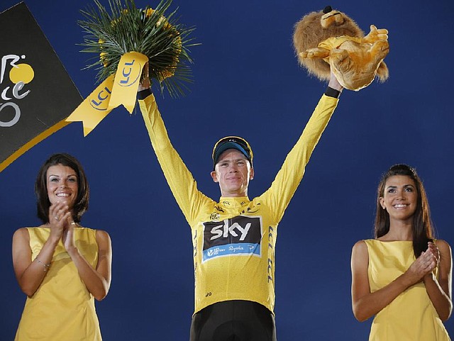 2013 Tour de France cycling race winner Christopher Froome of Britain, wearing the overall leader's yellow jersey, celebrates on the podium of the 100th edition of the Tour de France cycling in Paris, France, Sunday July 21 2013. (AP Photo/Christophe Ena)