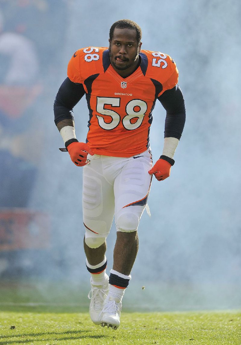 FILE - In this Dec. 30, 2012 file photo, Denver Broncos outside linebacker Von Miller runs onto the field prior to an NFL game against the Kansas City Chiefs  in Denver. A person with knowledge of the situation says Pro Bowl linebacker Von Miller will miss the first month of the season for violating the NFL's drug policy, pending an appeal. The person spoke to The Associated Press on condition of anonymity because the league hasn't announced any punishment. (AP Photo/Jack Dempsey, File)
