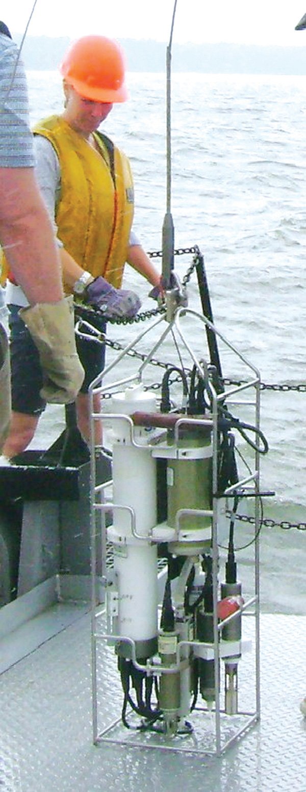 Merri Herndon, sixth-grade science teacher at Tyson Middle School, lowers equipment into the water at Chesapeake Bay on July 12 to test water temperature and density. Herndon was in Annapolis, Md., participating in an oceanography training program for teachers. 