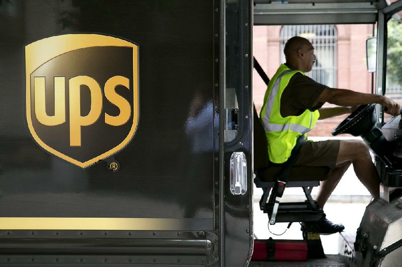 United Parcel Service Inc. driver Eric Brooks pulls away after making a delivery in Washington, D.C., on Monday. UPS said Tuesday that its second-quarter profit fell 4 percent. 