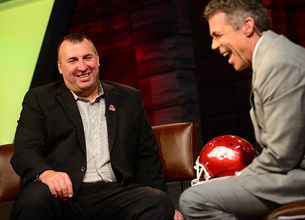 Arkansas coach Bret Bielema (left) shares a laugh with ESPN anchor Chris Fowler on Tuesday at ESPN headquarters in Bristol, Conn. 