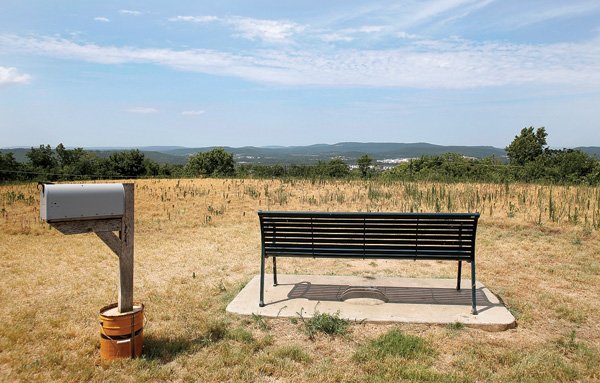 A mailbox and a bench placed in memory of Bruce and Barry Hauser sit on top of Mount Sequoyah Gardens at 100 North Summit Ave. in Fayetteville. The former site of an abandoned water treatment facility and water storage tank, Fayetteville has begun a project that will include replacing the asphalt access road, installing an arbor with flagstone paving, building a native stone seat wall, a colored concrete apron and accessible parking. The project is paid for with Parks Development tax revenue. Construction is expected to be done in November. 