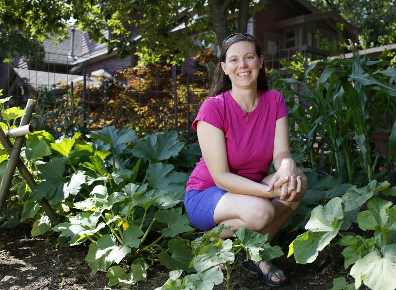 Corrin Troutman, a horticulturalist with the Peel-Compton Foundation, sits in her favorite personal space the vegetable garden in front of her Fayetteville home.
