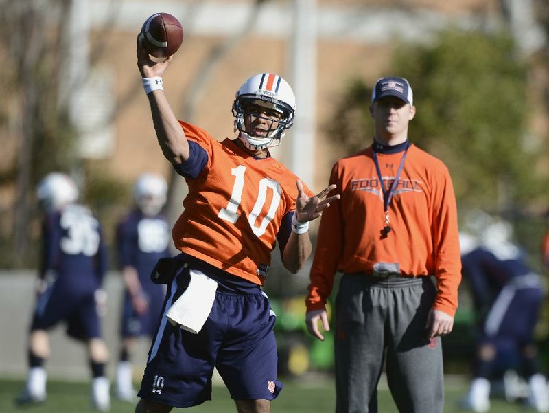 FILE- July 25,2013 - Auburn quarterback Kiehl Frazier makes a throw in practice as offensive coordinator Rhett Lashlee watches. Frazier, the former Shiloh Christian standout, struggled last season, but is hoping the new coaching staff, led by former Springdale High and Shiloh coach Gus Malzahn, will help revive his career. (AUBURN SPORTS INFORMATION/TODD VAN EMST)