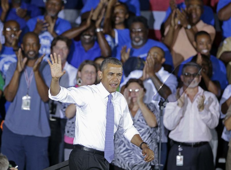 President Barack Obama waves  as he arrives to speak about the economy, Thursday, July 25, 2013, at the Jacksonville Port Authority in Jacksonville, Fla. A day after he kicked off the tour in Illinois and Missouri, Obama was traveling Thursday to a seaport in Jacksonville, Fla., to yet again deride the wide gulf between his vision for a new American prosperity driven by a burgeoning middle class and the intense gridlock snarling up Congress. (AP Photo/John Raoux)