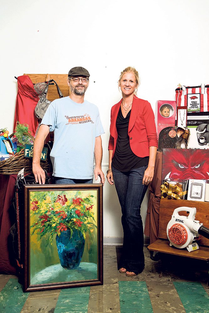 Artist Steve Griffith and Marci Martin, St. Joseph School bazaar auction coordinator, show off prizes that have been donated for the bazaar.