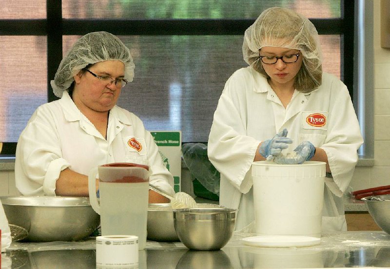 NWA Media/DAVID GOTTSCHALK

7/12/13

Brenda McIlvain (left), food technician for research and development, and Lily Benner, summer intern, bread cuts of chicken Friday morning in one of the test kitchens at the Tyson Discovery Center in Springdale during an internal product review.