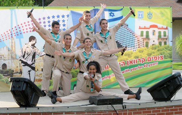 STAFF PHOTO SAMANTHA BAKER w @NWASamantha
Scouts from the Tzofim Friendship Caravan sing Thursday, July 25, 2013, at Lawrence Plaza in Bentonville during a stop on the performance group's tour. The group of teens is one of four traveling performance groups of Israeli Scouts who dance and sing to songs about friendship and Israel. The performance was sponsored by the Arkansas Jewish Federation and hosted by both Congregation Etz Chaim of Bentonville and Temple Shalom in Fayetteville.