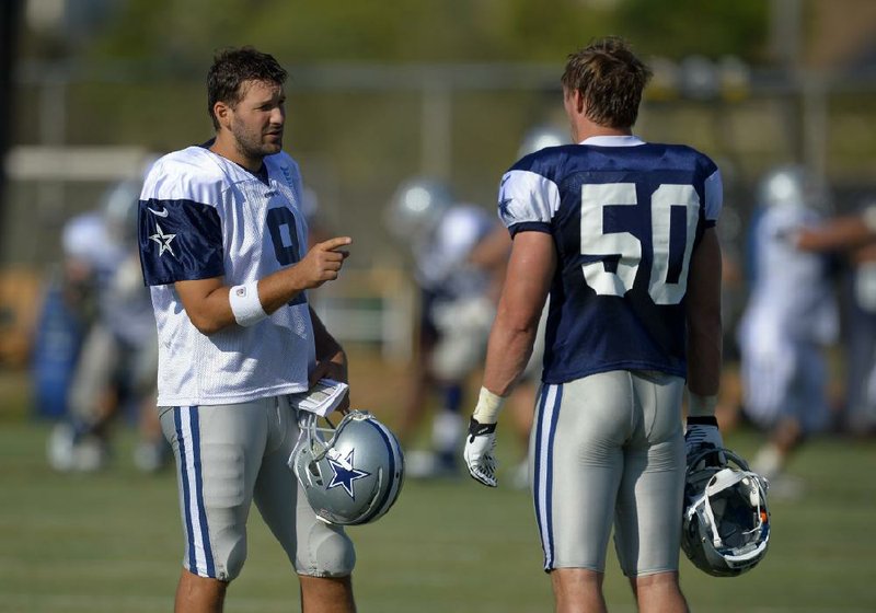 Dallas Cowboys quarterback Tony Romo, left, and inside linebacker Sean Lee talk during NFL football training camp, Friday, July 26, 2013, in Oxnard, Calif. (AP Photo/Mark J. Terrill) 