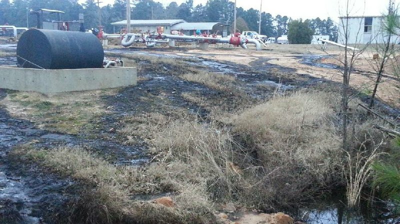 In this file photo provided by the U.S. Environmental Protection Agency oil covers the ground after a crude-oil spill at a Lion Oil facility near Magnolia.
