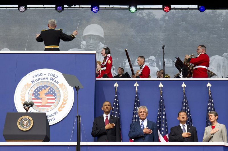President Barack Obama, left, Defense Secretary Chuck Hagel, Secretary of the Department of Veterans Affairs Eric Shinseki, and Secretary of the Interior Sally Jewell, attend a commemorative ceremony on the 60th anniversary of the end of the Korean War, near the Korean War Veterans Memorial on the National Mall in Washington, on Saturday, July 27, 2013. (AP Photo/Jacquelyn Martin)