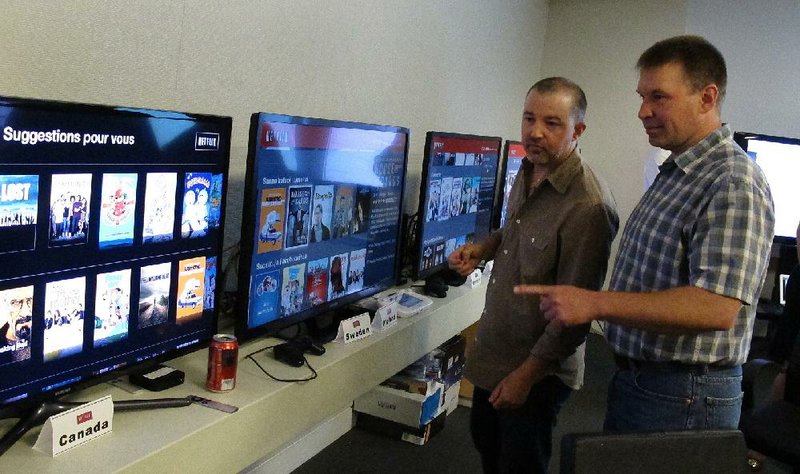 CORRECTS NAME OF MAN AT LEFT TO JAFFE - In this photo taken Wednesday, July 10, 2013, Chris Jaffe, Netflix VP of Product Innovation, left, and Bob Heldt, Director of Engineering, look over video displays as they await the debut of "Orange is the new black" in Los Gatos, Calif. (AP Photo/Michael Liedtke)