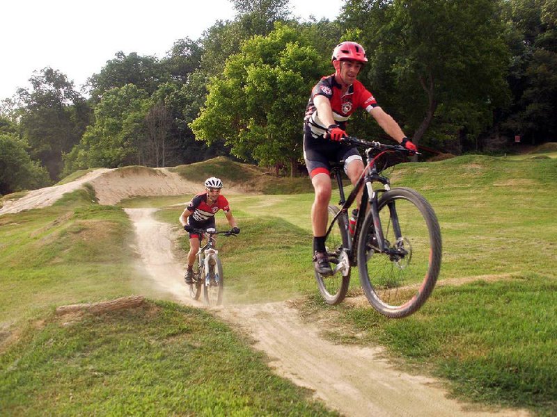 Special to the Democrat-Gazette/BOB ROBINSON

Michael Crawford and Del Groh, members of the Phat Tire Mountain Bike Race Team, have fun July 1 on Free Ride Park rollers at the Slaughter Pen Mountain BIke Trail System in Bentonville.