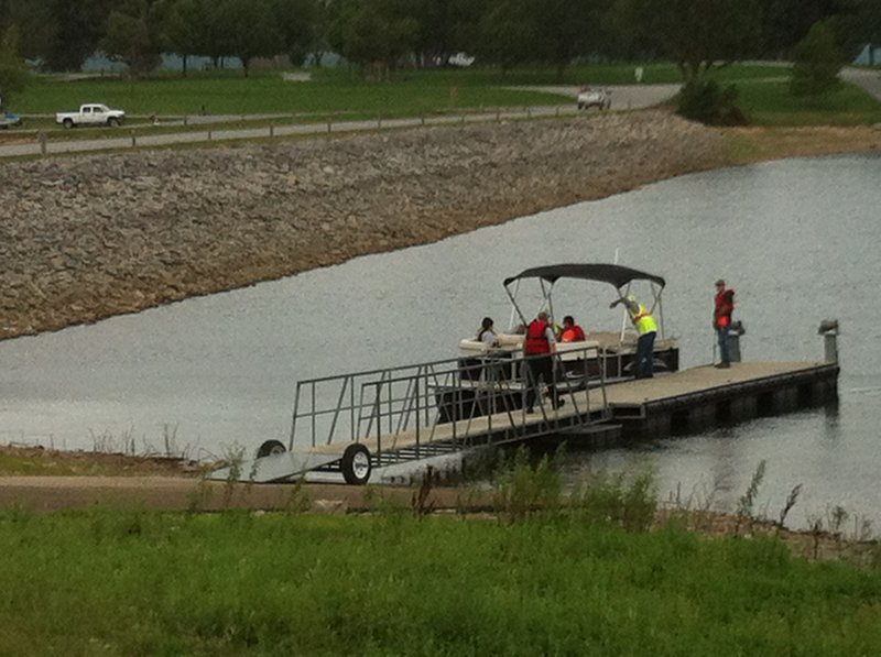 Cadaver dogs from St. Louis load into a boat on Beaver Lake near Dam Site Park in Eureka Springs to locate the body of missing fisherman Michael Burton from Omaha, Neb. 