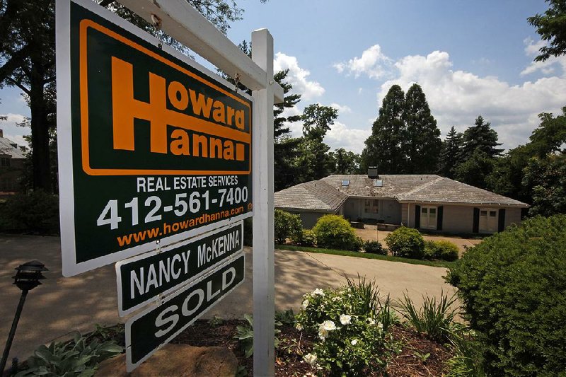 In this a Tuesday, July 32, 2013, photo, a home is sold in Mt. Lebanon, Pa., Tuesday, July 23, 2013.  The number of Americans who signed contracts to buy homes dipped in June from a six-year high in May, a sign that sales could stabilize over the next few months. (AP Photo/Gene J. Puskar)