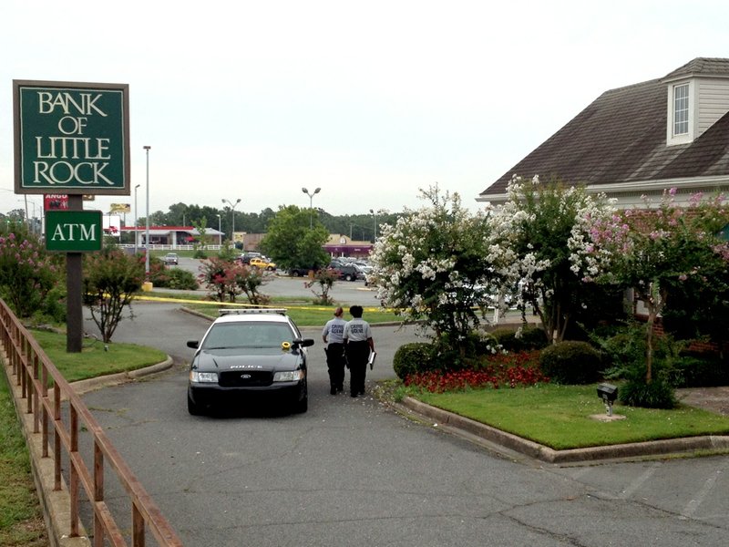 Little Rock police respond Tuesday, July 30, 2013, to report of a robbery at the Bank of Little Rock branch on Rodney Parham Road.