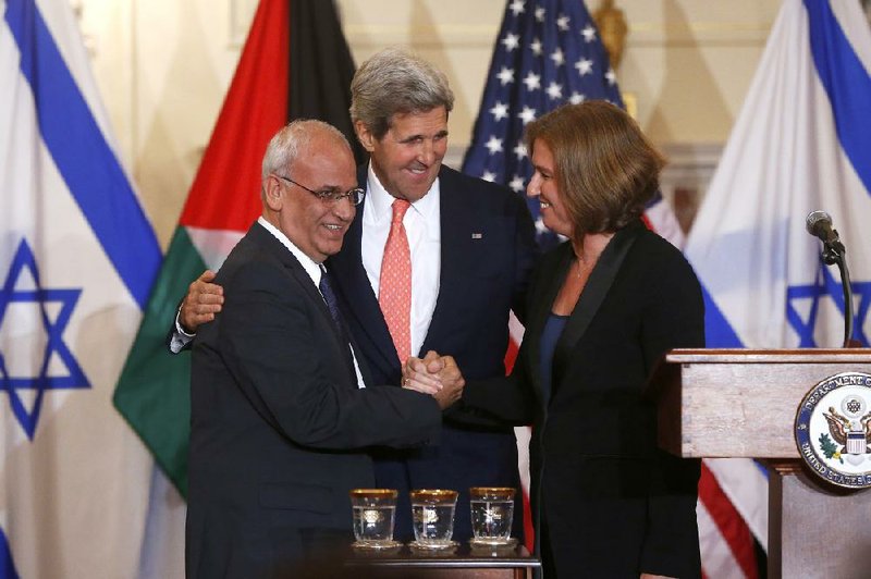 Secretary of State John Kerry (center) coaxes Palestinian negotiator Saeb Erekat (left) and Israel’s Tzipi Livni to shake hands Tuesday after a round of talks at the State Department in Washington, D.C. 