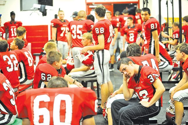 Farmington players wait in the team’s locker room Sept. 7, 2012, while waiting in the team’s locker room during a lightning delay in the Cardinals’ 25-0 weather-shortened win over West Fork. 