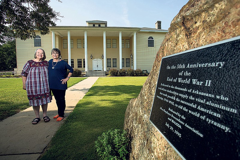 Jane Wilmoth, left, and Bauxite Museum Curator Melba Shepard stand in front of the museum. The facility houses exhibits that bring to life the heyday past of Bauxite, when the community boasted 15,000 to 20,000 inhabitants and played a huge role in helping the Allies win World War II.