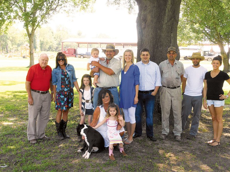 The Graham family of Tuckerman is the 2013 Jackson County Farm Family of the Year. Members of the family include, back row, from the left, Henry Gustave “Gus” Graham Jr., Stefanie Graham Poe, Haven Holladay, baby Charles Lowndes “Charlie” Steel VI, Henry Gustave “Gus” Graham III, Sarah Graham Steel, Charles Lowndes “Charlie” Steel V, Glenn Graham, Zack Graham and Abbi Graham; and front row, from the left, Boss the dog, Tami Graham and London Holladay.