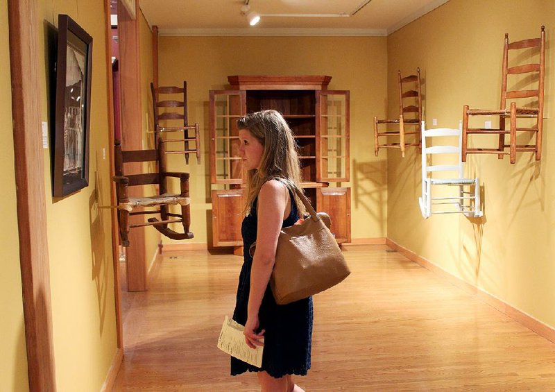 Maddie Miller, 18, of Little Rock looks at works inside the Arkansas Made Gallery at the Historic Arkansas Museum. 
