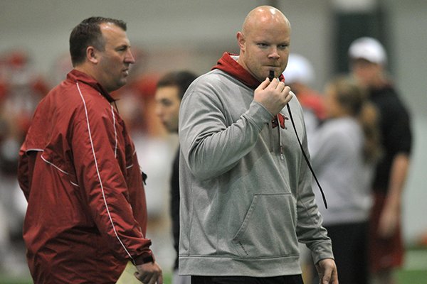 Arkansas Head Strength and Conditioning Coach Ben Herbert works with the Razorbacks during practice Saturday March 30, 2013 in Fayetteville. 