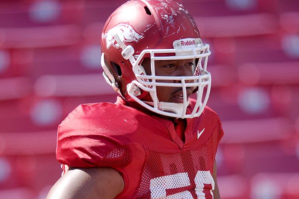 Arkansas offensive tackle Grady Ollison works out during a spring practice in Fayetteville. 