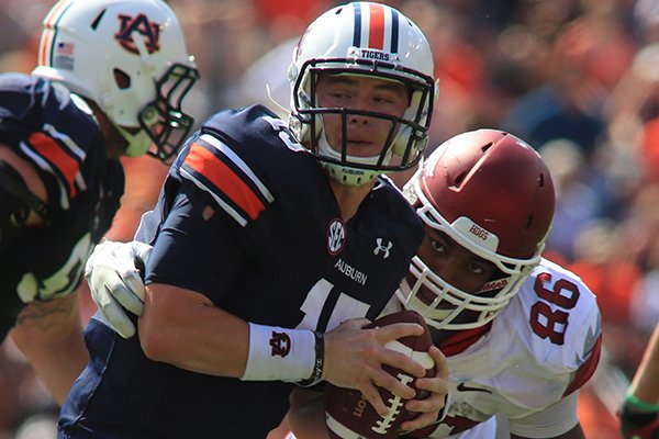 Arkansas defensive end Trey Flowers grabs Auburn quarterback Clint Moseley for a sack in their game at Jordan-Hare Stadium in Auburn, Ala. on Saturday Oct. 6, 2012.