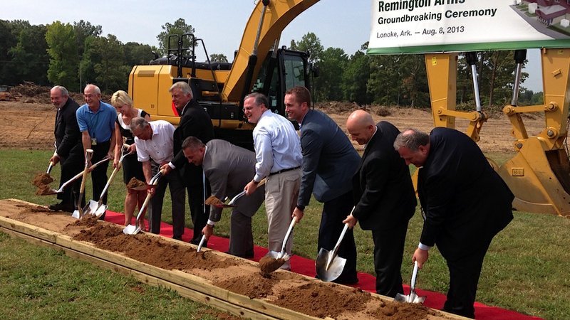 Gov. Mike Beebe (fifth from left), Sen. Mark Pryor (center in light blue shirt) and officials with Remington Guns and Ammunition break ground on the company's new, $32 million facility expansion in Lonoke. 