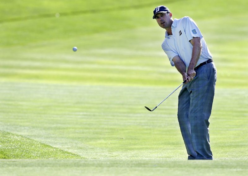 Matt Kuchar chips on the 13th hole during the first round of the PGA Championship golf tournament at Oak Hill Country Club, Thursday, Aug. 8, 2013, in Pittsford, N.Y. (AP Photo/Charlie Neibergall)