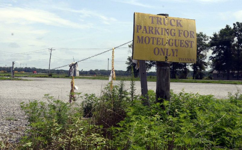 Arkansas Democrat-Gazette/JESSICA SEAMAN - 08-08-2013 - Fayetteville Shale update - The lot across the street from the Super 8 motel in Searcy use to be filled with trucks from the state's natural gas industry. Now the lot is empty has the motel has seen a decline in customers in the past few years as work in the Fayetteville Shale has slowed. 