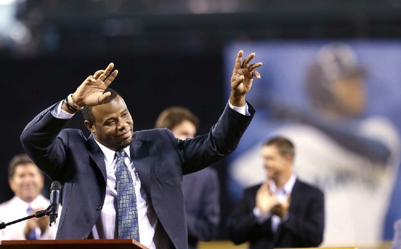 Former Seattle Mariners' outfielder Ken Griffey Jr. waves after speaking during a pregame ceremony to induct him into the team's Hall of Fame Saturday, Aug. 10, 2013, in Seattle. (AP Photo/Elaine Thompson)