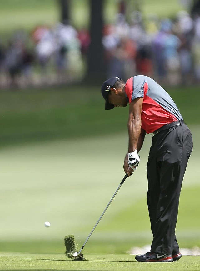 Tiger Woods hits from the fairway on the 13th hole during the final round of the PGA Championship golf tournament at Oak Hill Country Club, Sunday, Aug. 11, 2013, in Pittsford, N.Y. (AP Photo/Julio Cortez) 