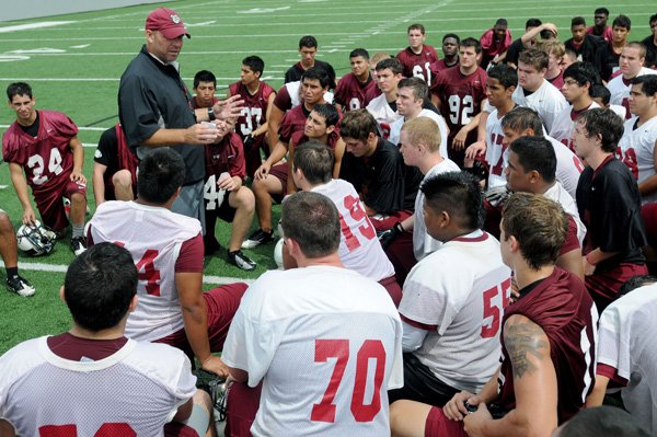 Shane Patrick, Springdale High football coach, talks to his players after Thursday’s practice at Bulldog Stadium in Springdale. Patrick and the coaching staff are excited about the offensive line this season. He said the inexperienced group has made progress in practice. 