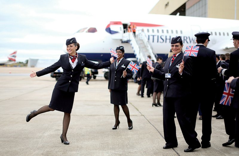 British Airways flight attendants pose for photographs July 4 in front of a new Boeing 787 Dreamliner at Heathrow airport near London. 