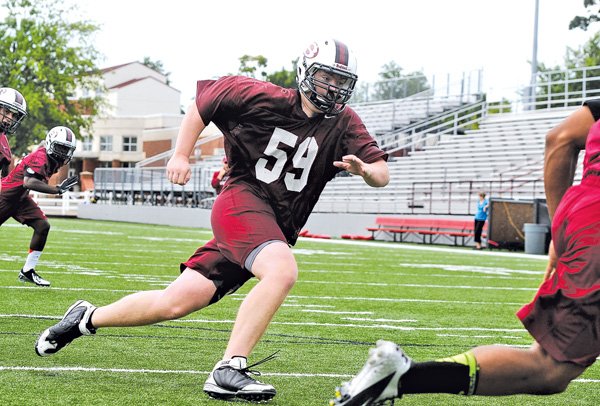 Austin Jarrett, Springdale High senior, pursues a ballcarrier Aug. 8 during football practice at Bulldog Stadium
in Springdale.