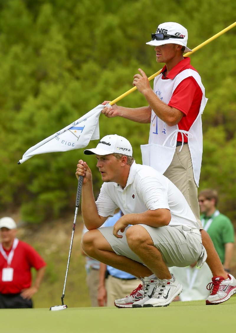 8/3/13
Arkansas Democrat-Gazette/STEPHEN B. THORNTON
Arkansas Razorback Sebastian Cappelen talks with his caddy on the first hole during a playoff in his match play against Robby Shelton during the Western Amateur at the Alotian Club in Roland Saturday.