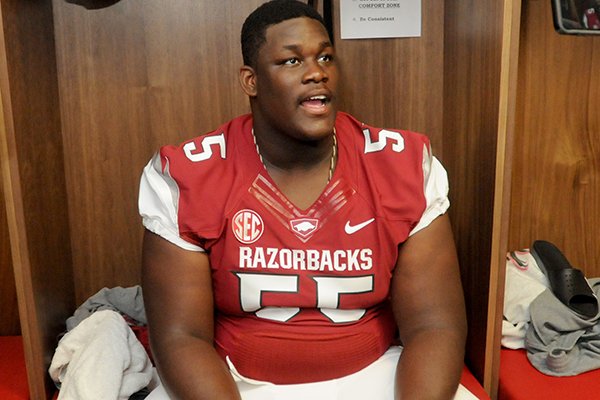 Arkansas offensive guard Denver Kirkland talks with reporters Sunday, Aug. 11, 2013 during media day in Fayetteville.