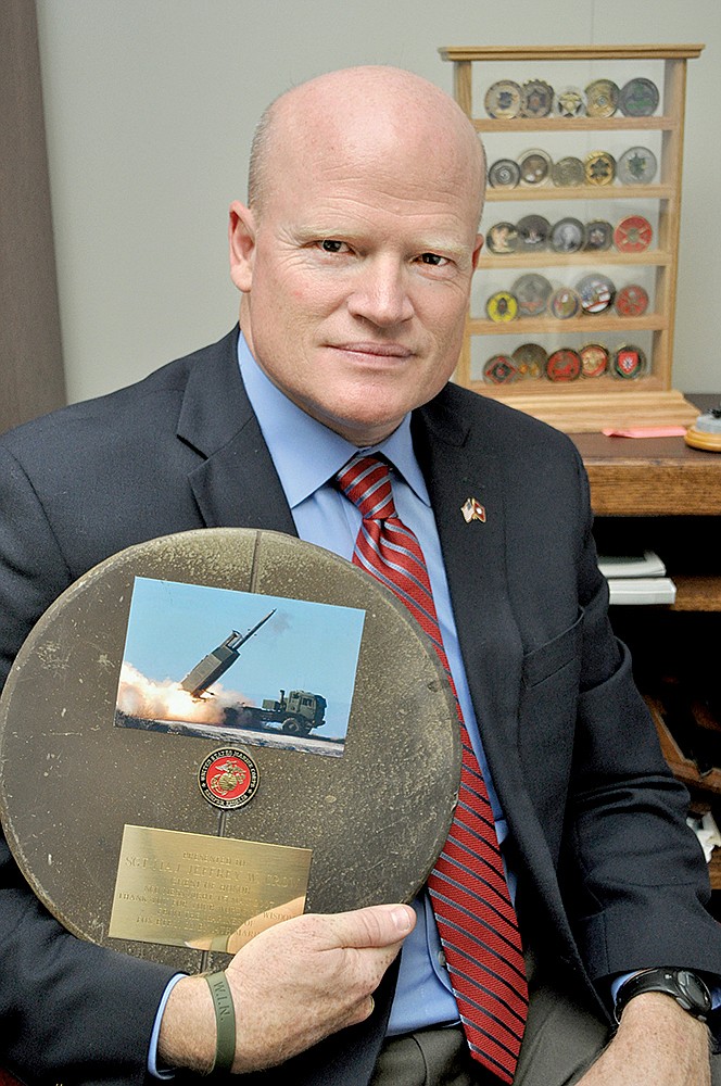 Jeff Crow, new deputy director for the Arkansas Game and Fish Commission, holds a plaque that was given to him by the noncommissioned officers of Fox Battery, 2nd Battalion, 14th Marines. The officers presented the plaque to Crow when he was a guest speaker at a dinner hosted by the battalion.