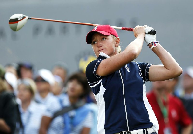 United States'  Stacy Lewis tees off on the first hole during the opening foursome match in the Solheim Cup golf tournament, Friday, Aug. 16, 2013, in Parker, Colo. (AP Photo/Ed Andrieski)
