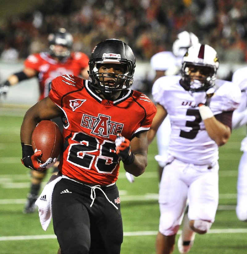 Arkansas State running back David Oku runs for a 6 yard touchdown during the 3rd quarter of the Red Wolves 45-23 victory over ULM at Liberty Bank stadium Thursday night in Jonesboro.

Special to the Arkansas Democrat Gazette/JIMMY JONES