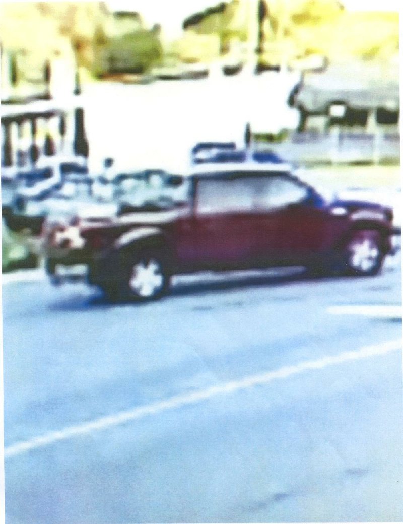 Special to the Arkansas Democrat-Gazette--08/16/13--  A photo taken from a video camera of a maroon Ford crew-cab pickup truck, 2007-10 model that is believed to be the one that was heading west on McCain Blvd. last Wednesday evening when a male fired a pistol from it at the intersection of JFK and McCain blvds. killing a female as she was driving east on McCain Blvd. A baby in her vehicle was not injured.