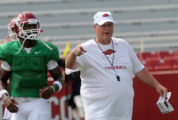 Arkansas offensive coordinator Jim Chaney watches the team warm up before Saturday's scrimmage at Donald W. Reynolds Razorback Stadium in Fayetteville.
