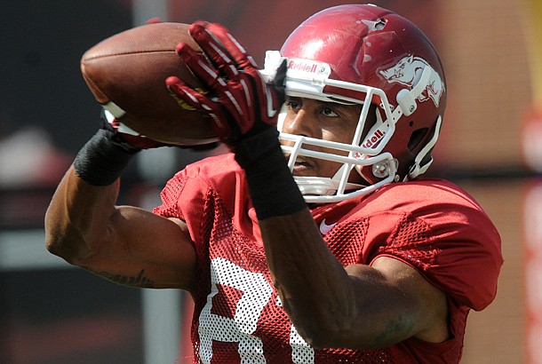 Arkansas wide receiver Demetrius Wilson warms up at the first fall scrimmage at Donald W. Reynolds Razorback Stadium in Fayetteville. Arkansas coach Bret Bielema announced the senior wide receiver tore his ACL.