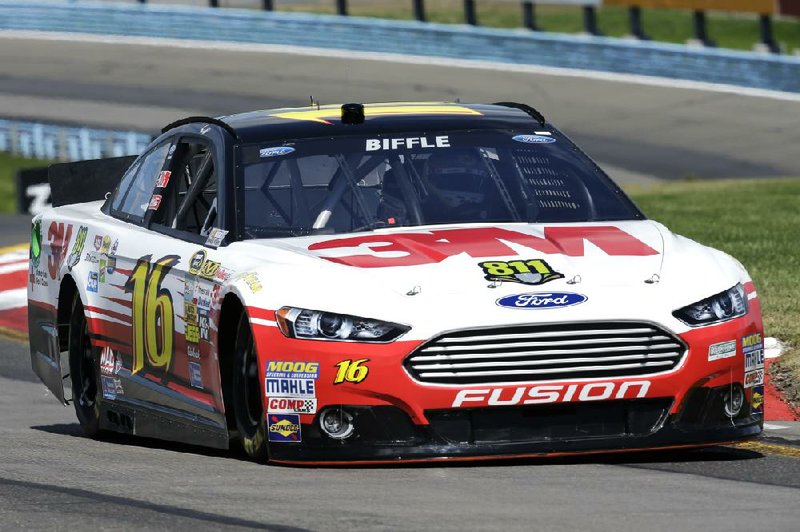  drives in the garage area during qualifying for Sunday's NASCAR Sprint Cup Series auto race, Saturday Aug. 10, 2013, in Watkins Glen, N.Y.  (AP Photo/Mel Evans)