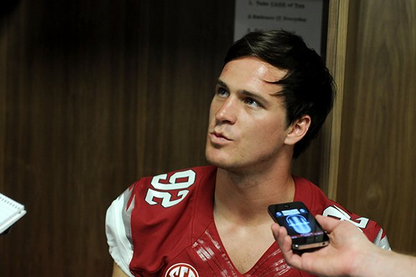 Arkansas junior punter Sam Irwin-Hill, answers questions is during the school's media day Sunday, Aug. 11, 2013 at the Fred W. Smith Football Center in Fayetteville.